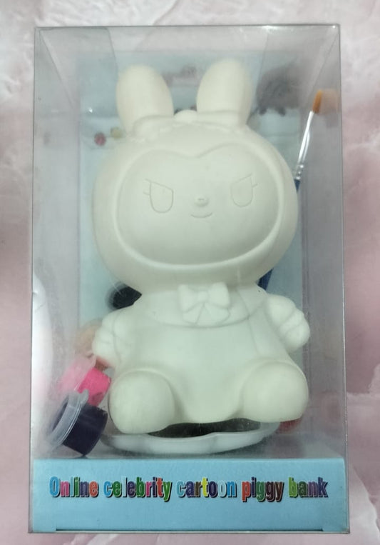 White cartoon-like piggy bank with a keychain in a clear packaging on a light pink background