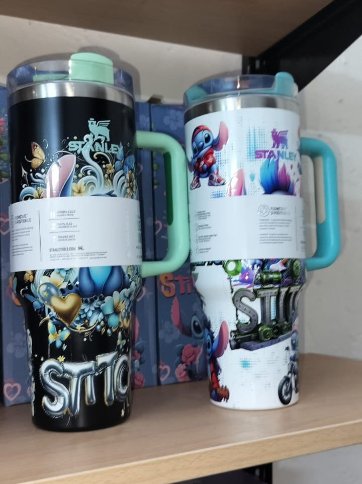 Two insulated tumblers with handles on a shelf